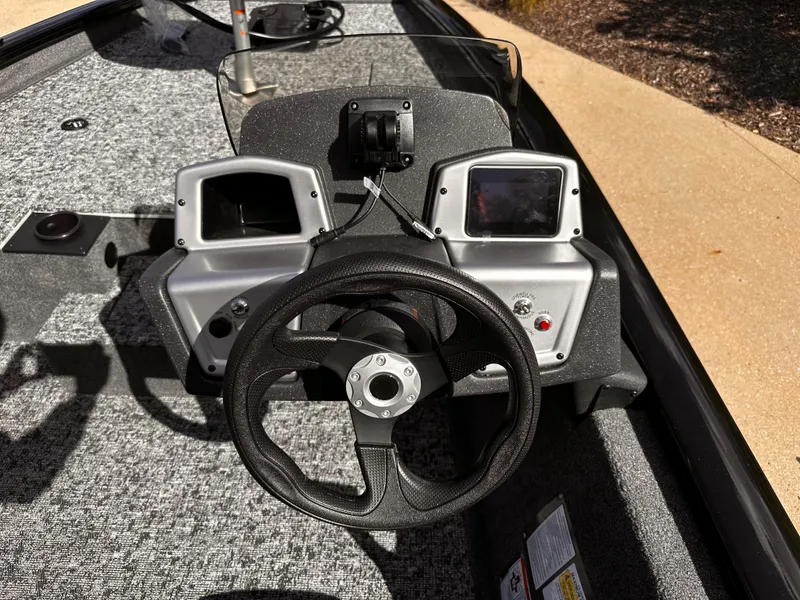 Slide: The Image of Steering console of 2025 Tracker Pro Team 175 boat with dual displays and controls. - 5
