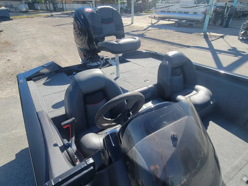 Slide: The Image of 2021 Tracker Pro Team 195 TXW boat interior with steering wheel and seating. - 13