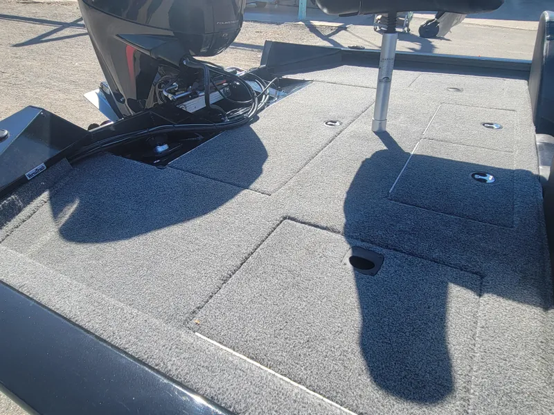 Slide: The Image of 2021 Tracker Pro Team 195 TXW boat deck with storage compartments and motor. - 14