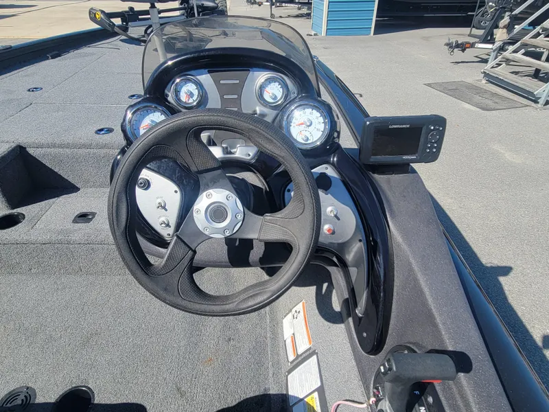 Slide: The Image of 2021 Tracker Pro Team 195 TXW boat dashboard with steering wheel and gauges. - 15