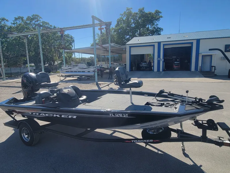 Slide: The Image of 2021 Tracker Pro Team 195 TXW fishing boat on trailer, parked outdoors. - 3