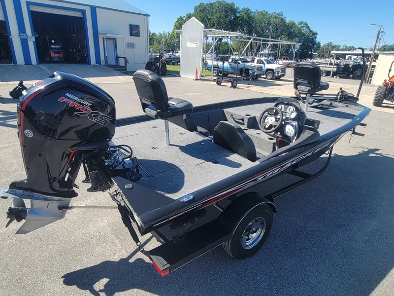 Slide: The Image of 2021 Tracker Pro Team 195 TXW boat with outboard motor in a parking lot. - 4