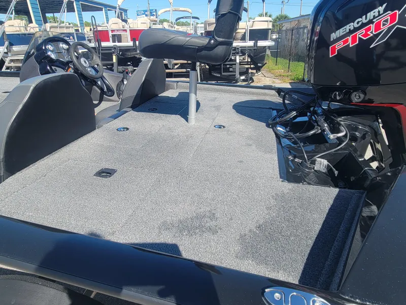 Slide: The Image of 2021 Tracker Pro Team 195 TXW boat with Mercury Pro engine, featuring spacious deck and seating. - 7