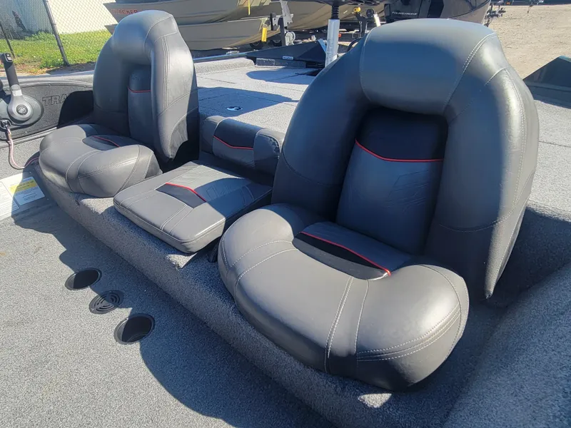 Slide: The Image of 2021 Tracker Pro Team 195 TXW boat seats, featuring gray upholstery with red accents. - 8