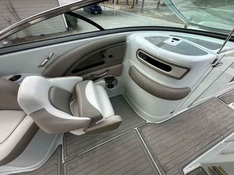 Slide: The Image of 2018 Crownline Eclipse E25 boat interior with gray seating and sleek dashboard design. - 11