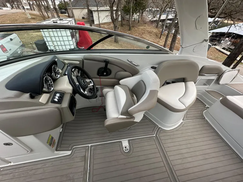 Slide: The Image of 2018 Crownline Eclipse E25 boat interior with steering wheel and seating area. - 12