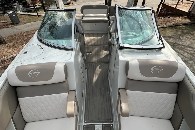 Slide: The Image of 2018 Crownline Eclipse E25 boat interior with beige seating and dual windshields. - 14