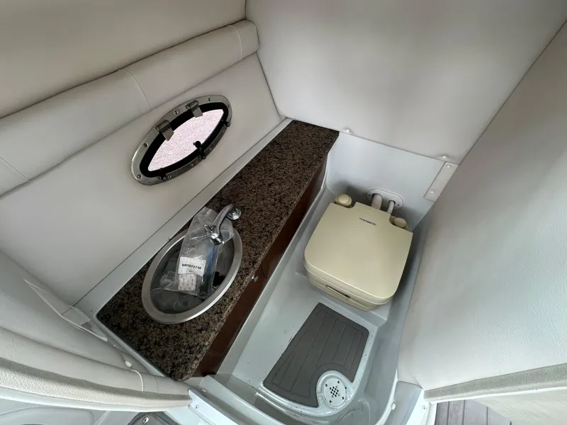Slide: The Image of 2018 Crownline Eclipse E25 boat interior with sink and portable toilet. - 19