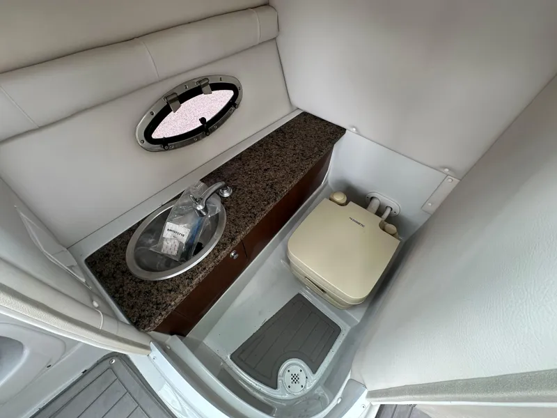Slide: The Image of 2018 Crownline Eclipse E25 boat interior with sink and portable toilet. - 20