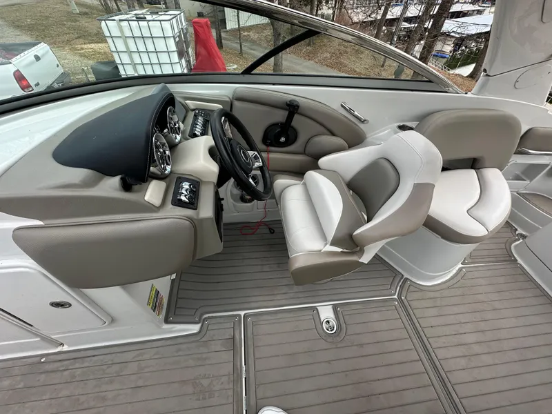 Slide: The Image of 2018 Crownline Eclipse E25 boat interior with steering wheel and seating area. - 6