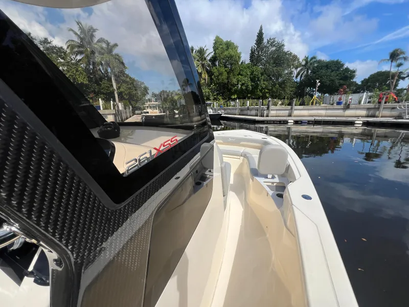 Slide: The Image of 2025 Scout 261 XSS boat docked, showcasing sleek design and luxurious seating. - 16