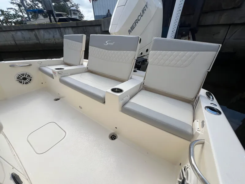 Slide: The Image of 2025 Scout 261 XSS boat seating area with cushioned seats and cup holders. - 17