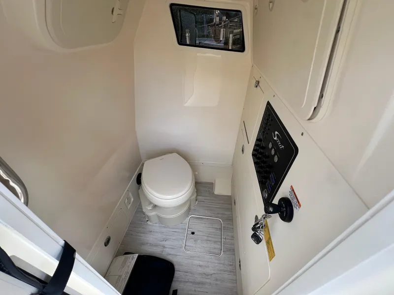 Slide: The Image of 2025 Scout 261 XSS boat interior with compact bathroom and control panel. - 18