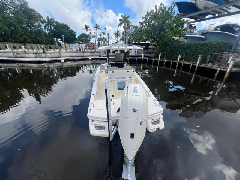 Slide: The Image of 2025 Scout 261 XSS boat docked in a serene marina setting. - 3