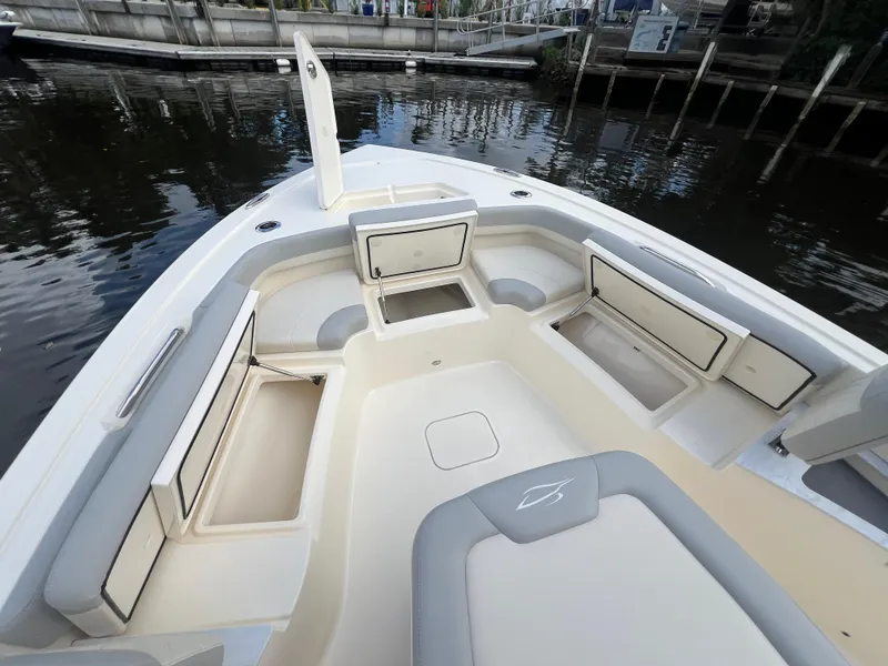 Slide: The Image of 2025 Scout 261 XSS boat interior with open storage compartments and seating. - 6