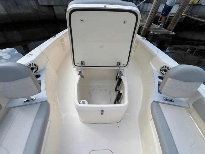 Slide: The Image of 2025 Scout 261 XSS boat interior with open storage compartment and seating. - 8