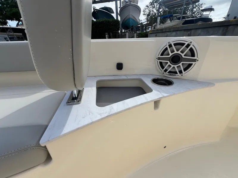 Slide: The Image of 2025 Scout 261 XSS boat interior with speaker and cup holder on white surface. - 9