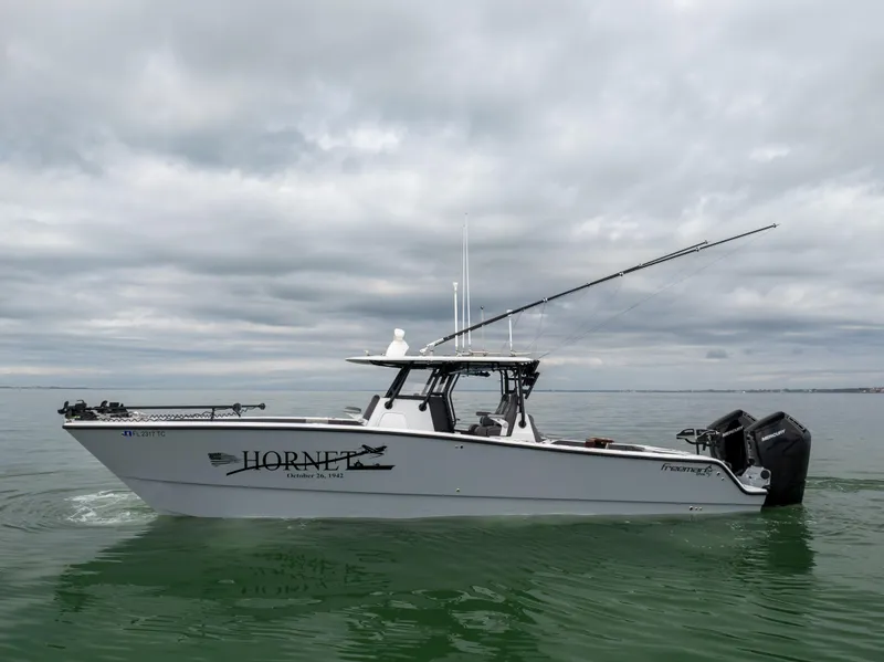 Slide: The Image of 2022 Freeman 37 VH boat on calm water under cloudy sky. - 11