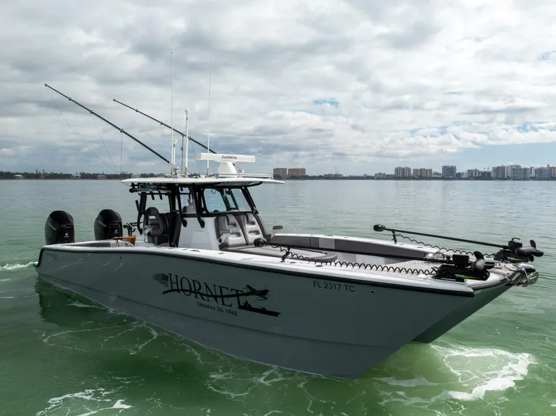 Slide: The Image of 2022 Freeman 37 VH boat on water, equipped with fishing gear and twin engines. - 17