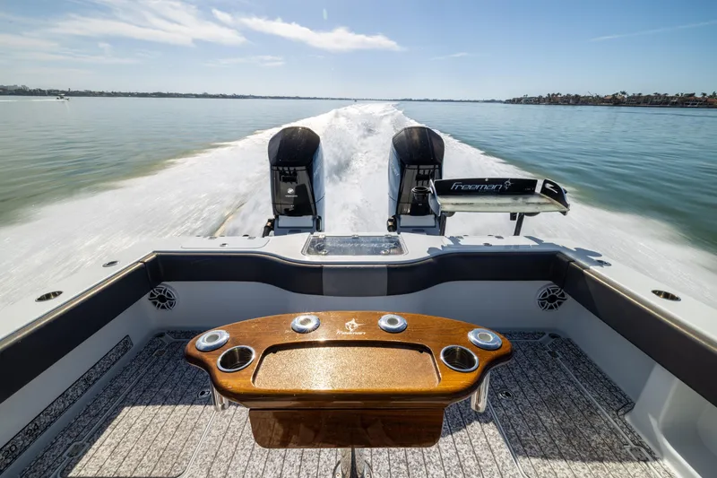 Slide: The Image of 2022 Freeman 37 VH boat cruising on calm water, showcasing dual engines and sleek design. - 19