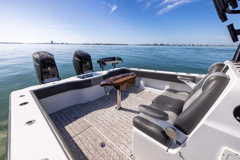 Slide: The Image of Freeman 37 VH 2022 boat interior with dual engines on calm water. - 22