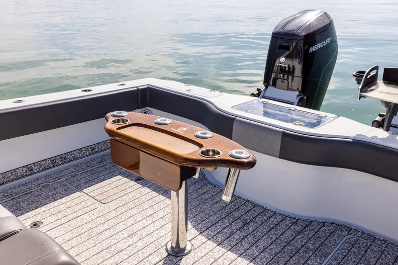 Slide: The Image of Freeman 37 VH 2022 boat interior with fishing rod holders and Mercury outboard motor. - 24