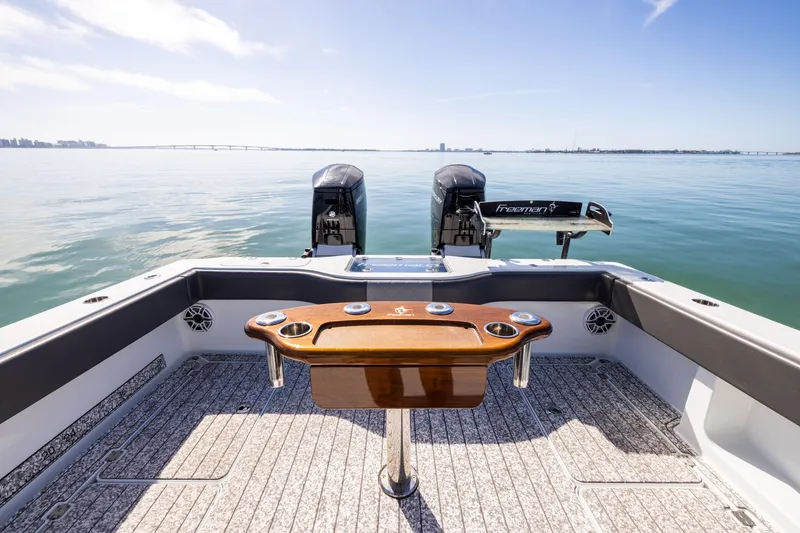 Slide: The Image of Freeman 37 VH 2022 boat with dual engines on calm water. - 25