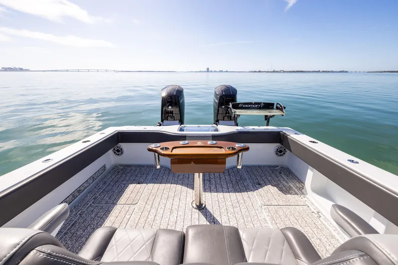 Slide: The Image of Freeman 37 VH 2022 boat with dual engines on calm water. - 26