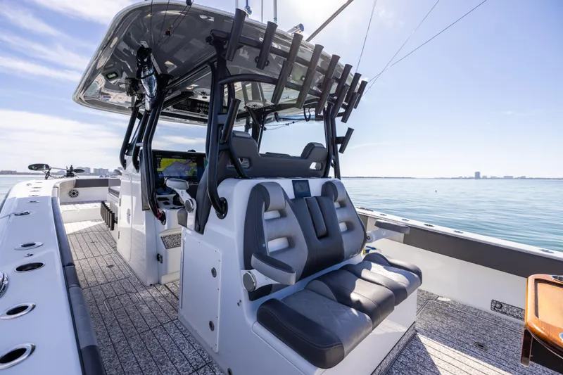 Slide: The Image of 2022 Freeman 37 VH boat interior with seating and rod holders on a sunny day. - 28