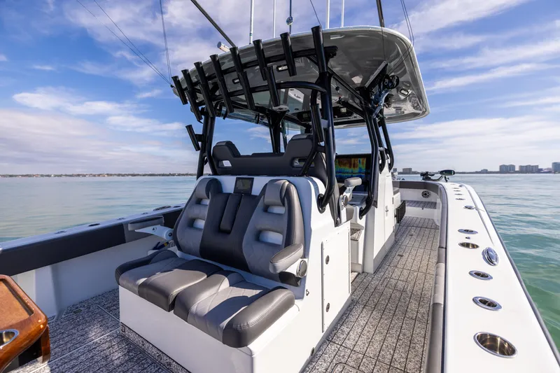 Slide: The Image of Freeman 37 VH 2022 boat interior with seating and rod holders on calm water. - 29