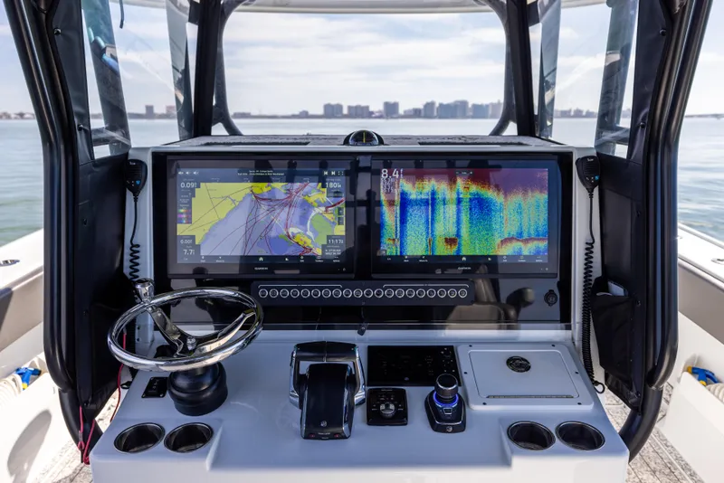 Slide: The Image of 2022 Freeman 37 VH boat dashboard with navigation screens and steering wheel. - 34