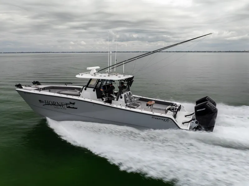 Slide: The Image of 2022 Freeman 37 VH boat speeding on water under cloudy skies. - 4