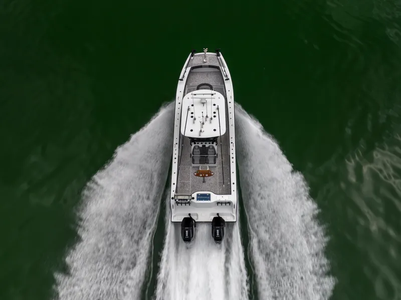 Slide: The Image of Aerial view of 2022 Freeman 37 VH boat speeding on green water. - 7