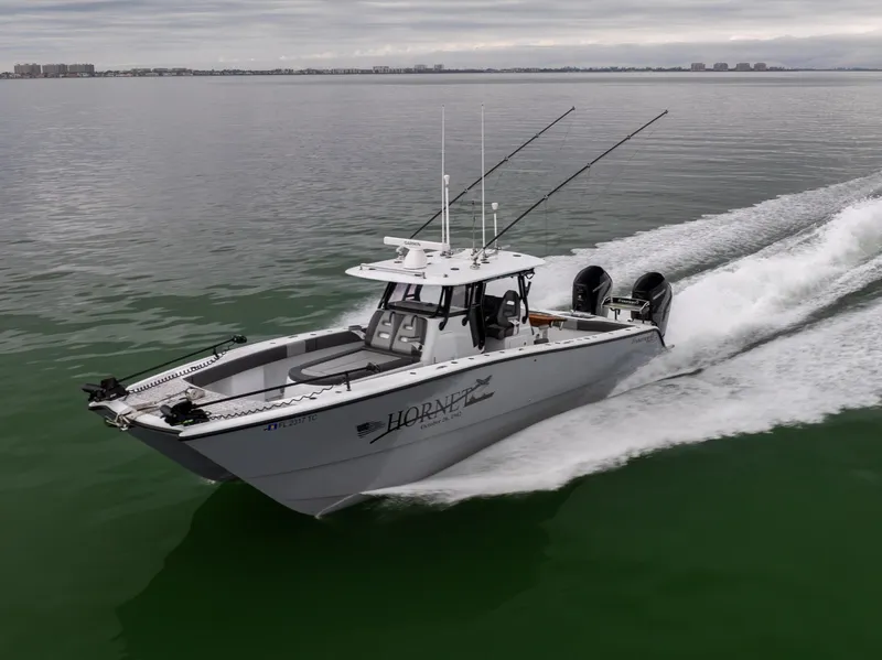 Slide: The Image of 2022 Freeman 37 VH boat cruising on calm water with fishing rods. - 9