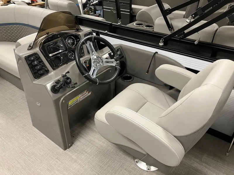 Slide: The Image of 2024 Qwest 816 XRE Cruise boat interior with steering console and captain's chair. - 4