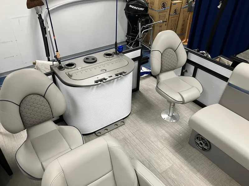 Slide: The Image of 2024 Qwest 816 XRE Cruise boat interior with plush seating and fishing rod holders. - 8
