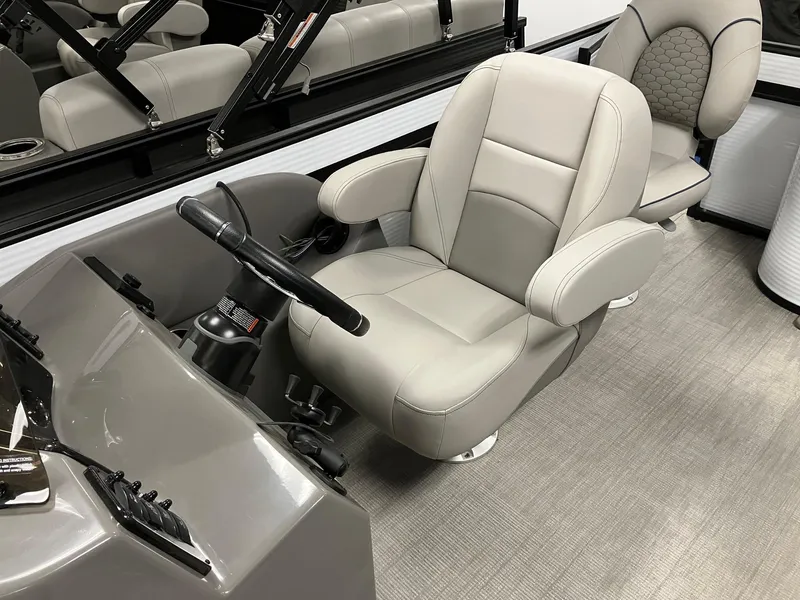 Slide: The Image of 2024 Qwest 816 XRE Cruise boat interior with plush captain's chair and steering console. - 9