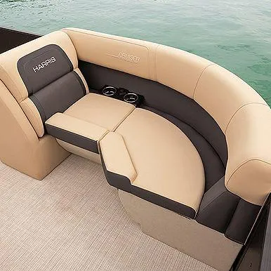 Slide: The Image of Luxurious seating on 2025 Harris Cruiser 210 boat, featuring beige and gray upholstery with cup holders. - 10