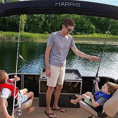 Slide: The Image of Family enjoying fishing on a 2025 Harris Cruiser 210 boat. - 9