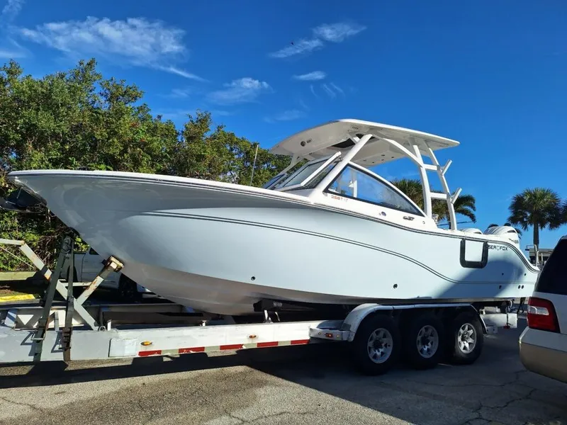 Slide: The Image of 2024 Sea Fox 268 Traveler boat on trailer, parked outdoors under clear blue sky. - 1