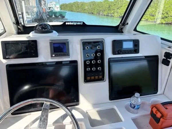 Slide: The Image of Control panel of a 2012 Everglades 325 Center Console boat with navigation equipment. - 11