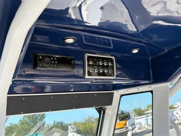 Slide: The Image of 2012 Everglades 325 Center Console boat dashboard with audio system and controls. - 13