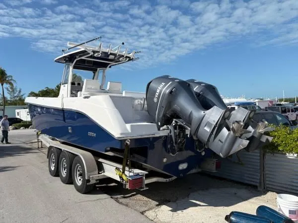 Slide: The Image of 2012 Everglades 325 Center Console boat on trailer with Yamaha outboard engines. - 2
