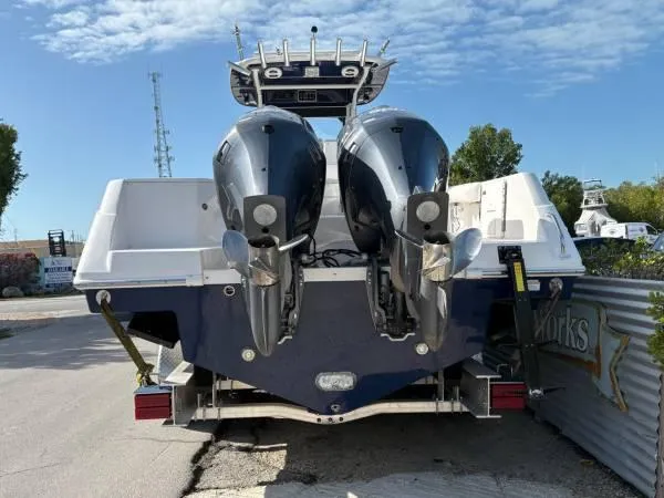 Slide: The Image of 2012 Everglades 325 Center Console boat with dual outboard motors on a trailer. - 3