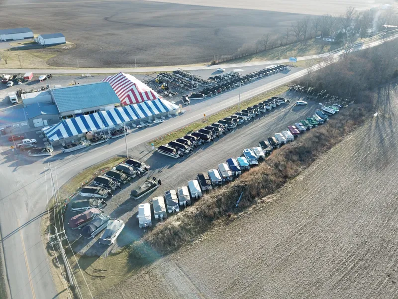 Slide: The Image of Aerial view of a large outdoor event with striped tents and parked vehicles. - 10
