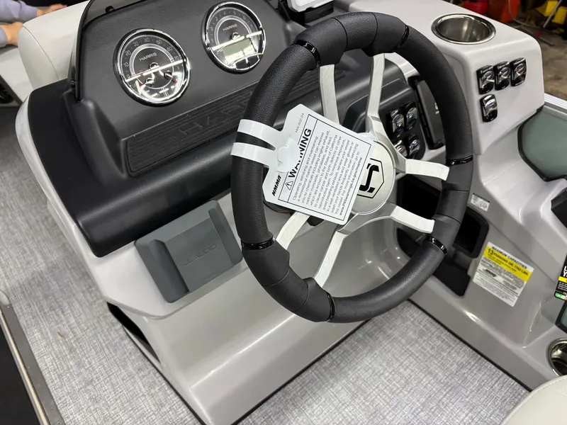 Slide: The Image of 2025 Harris CRUISER 230 SLDH steering console with gauges and controls. - 11