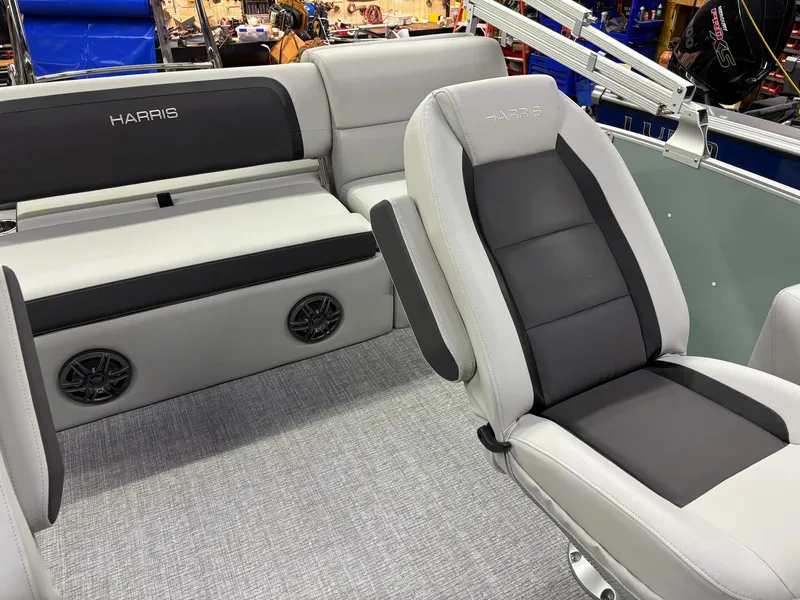 Slide: The Image of 2025 Harris CRUISER 230 SLDH boat interior with gray and black seating. - 12