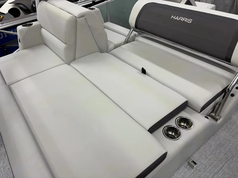 Slide: The Image of 2025 Harris CRUISER 230 SLDH boat interior with plush seating and cup holders. - 13