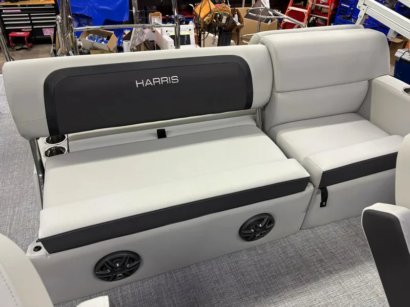 Slide: The Image of 2025 Harris CRUISER 230 SLDH boat seating with integrated speakers in a workshop setting. - 14