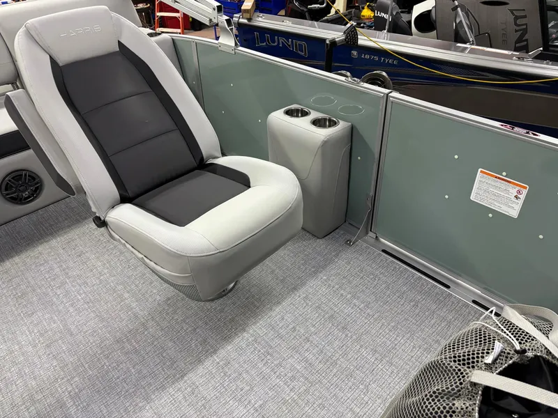 Slide: The Image of 2025 Harris CRUISER 230 SLDH boat interior with gray seating and cup holders. - 18